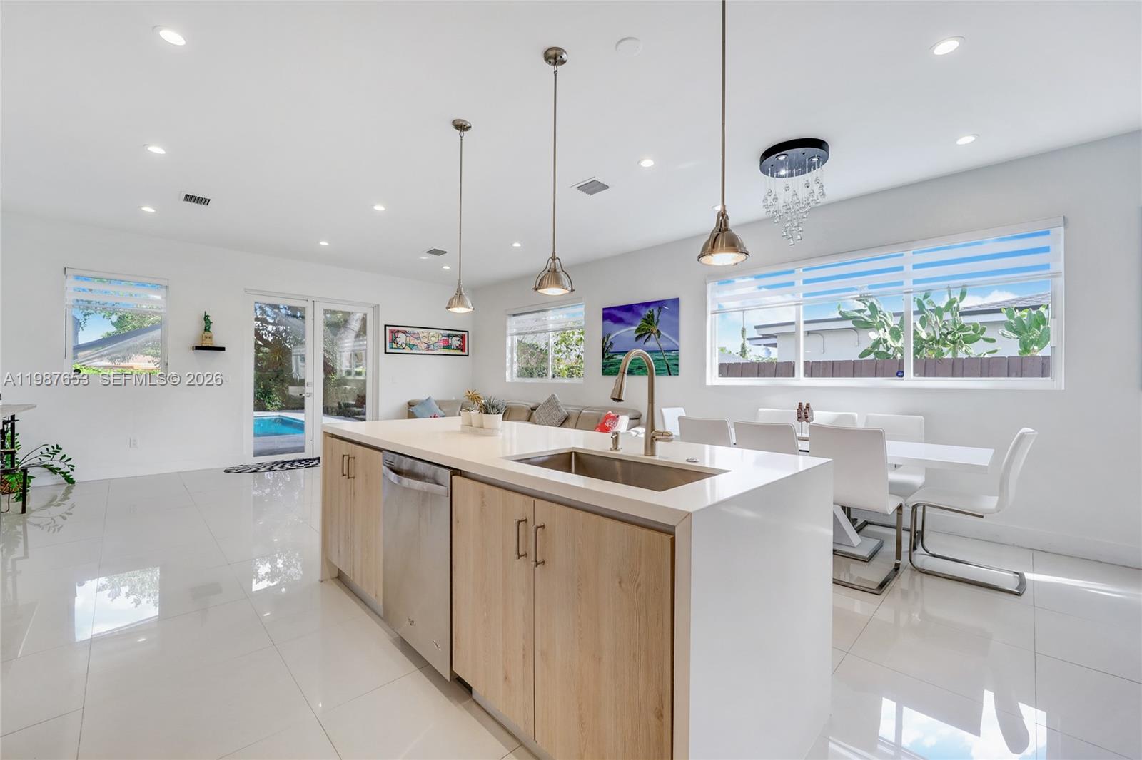 2943 Southwest 23rd Street Miami, FL 33145 - Photo 8 of 19 a kitchen with stainless steel appliances kitchen island a large island in the center