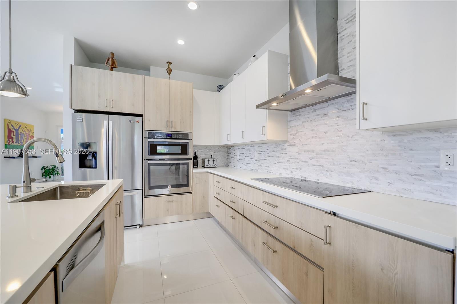 2943 Southwest 23rd Street Miami, FL 33145 - Photo 9 of 19 a kitchen with kitchen island granite countertop a sink stainless steel appliances and cabinets