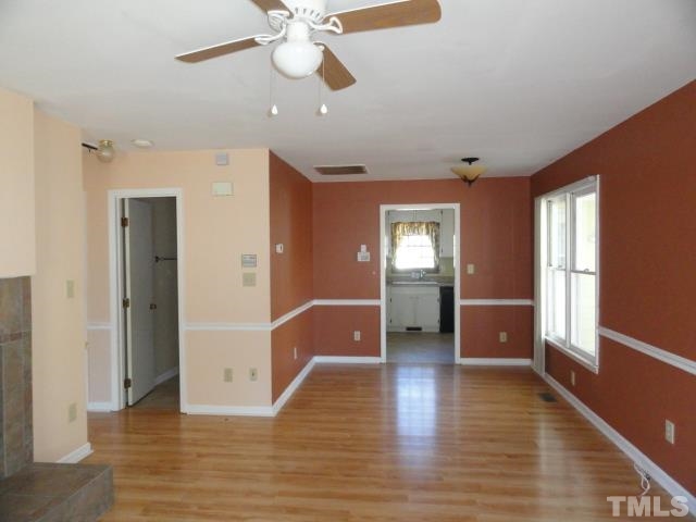 4204 Ferriday Court Raleigh, NC 27616 - Photo 2 of 9 a view of a hallway with wooden floor and workspace