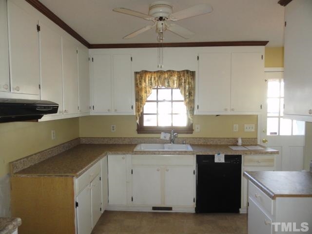 4204 Ferriday Court Raleigh, NC 27616 - Photo 4 of 9 a kitchen with a sink stove and cabinets