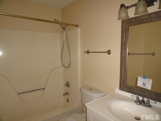 4204 Ferriday Court Raleigh, NC 27616 - Photo 5 of 9 a bathroom with a sink a toilet and shower