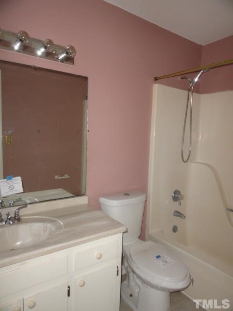 4204 Ferriday Court Raleigh, NC 27616 - Photo 8 of 9 a bathroom with a sink a toilet and shower