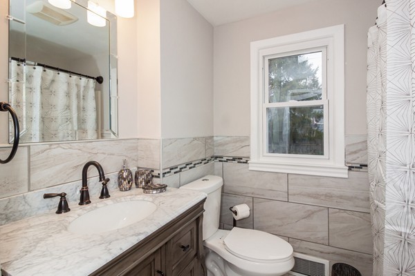 26 Kittrell Street Springfield, MA 01119 - Photo 11 of 21 a bathroom with a granite countertop toilet sink and mirror