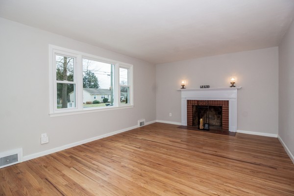 26 Kittrell Street Springfield, MA 01119 - Photo 3 of 21 a view of empty room with wooden floor and fireplace