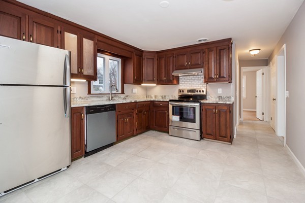 26 Kittrell Street Springfield, MA 01119 - Photo 7 of 21 a kitchen with stainless steel appliances granite countertop a stove top oven a refrigerator a sink and dishwasher