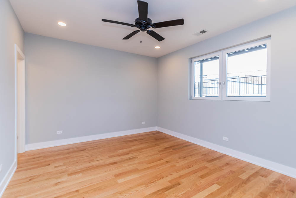 2307 West 19th Street, Unit 2 Chicago, IL 60608 - Photo 12 of 16 an empty room with a window and a fan