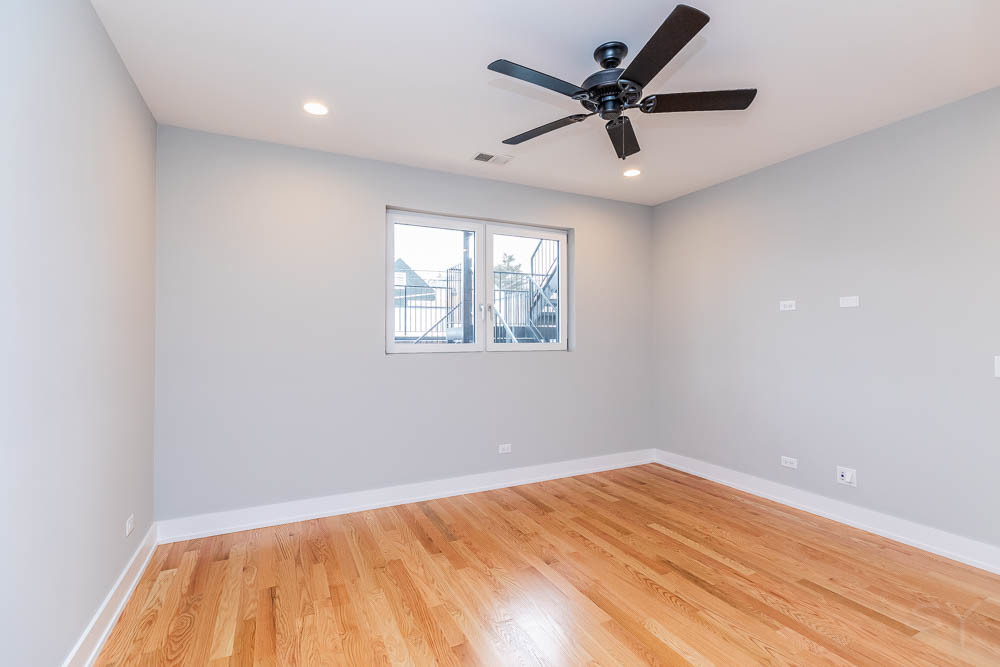 2307 West 19th Street, Unit 2 Chicago, IL 60608 - Photo 15 of 16 an empty room with a window and a ceiling fan