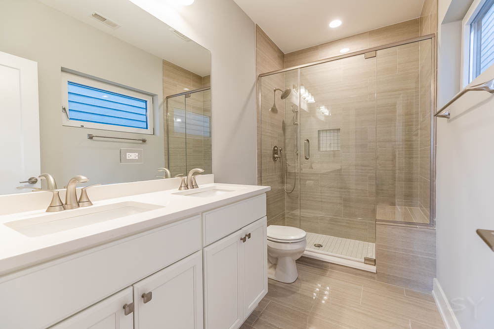 2307 West 19th Street, Unit 2 Chicago, IL 60608 - Photo 16 of 16 a bathroom with a double vanity sink toilet and shower