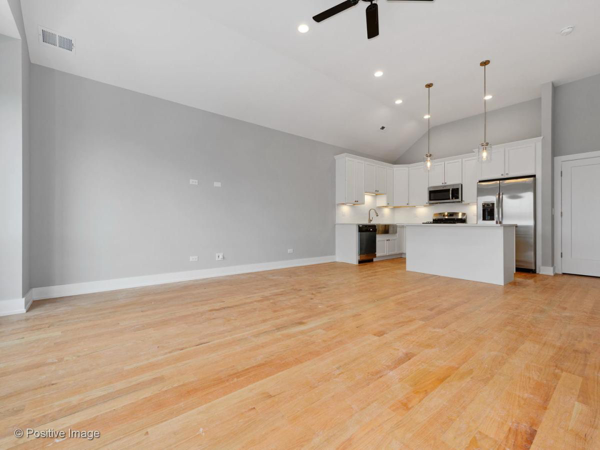 2307 West 19th Street, Unit 2 Chicago, IL 60608 - Photo 6 of 16 a view of a kitchen with a sink and a refrigerator