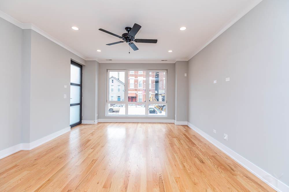 2307 West 19th Street, Unit 2 Chicago, IL 60608 - Photo 8 of 16 a view of an empty room with a window and wooden floor
