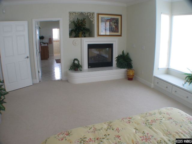 2950 Flint Ridge Court Reno, NV 89511 - Photo 4 of 7 a view of a livingroom with wooden floor and a fireplace