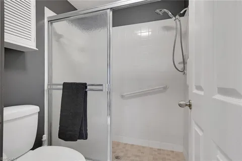 a bathroom with a toilet and shower
