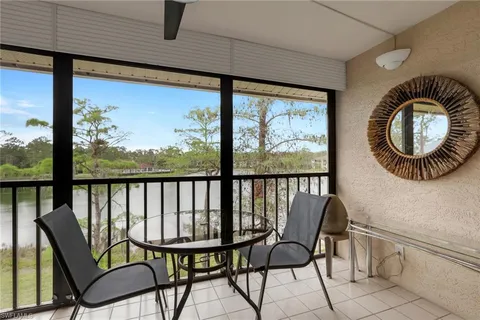 a view of a chairs and table in the balcony