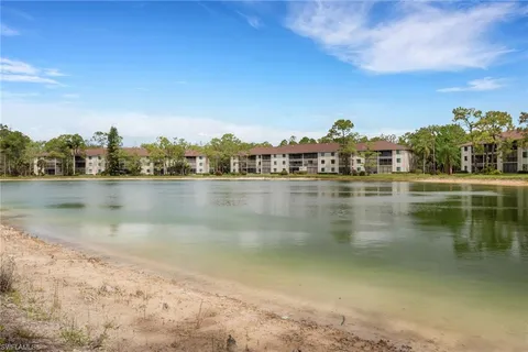 a view of a lake with houses in the back