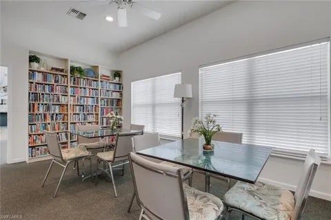 a view of a dining room with furniture and a chandelier