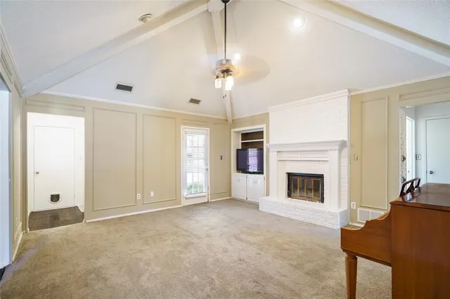 a view of livingroom with a fireplace cabinet and windows