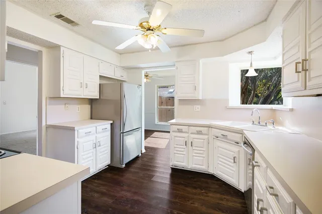 a kitchen with white cabinets and white appliances