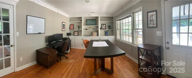 a view of a workspace with furniture and a window