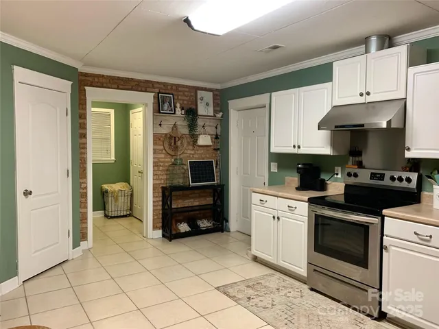 a kitchen with stainless steel appliances a stove a sink and a refrigerator
