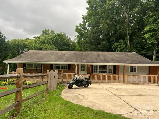 a view of a house with backyard porch and sitting area