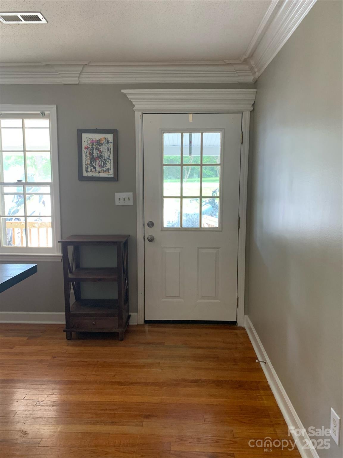 10672 Barberville Road Indian Land, SC 29707 - Photo 9 of 34 an empty room with wooden floor cabinet and windows