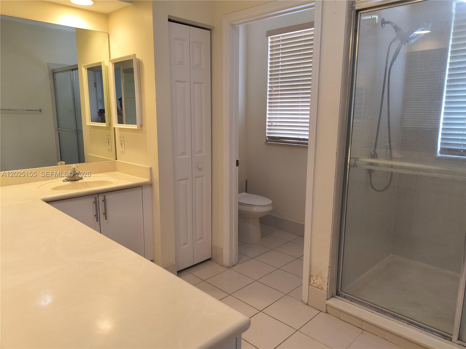 1645 Southeast 20th Road, Unit 1645 Homestead, FL 33035 - Photo 17 of 20 a bathroom with a sink a toilet and shower