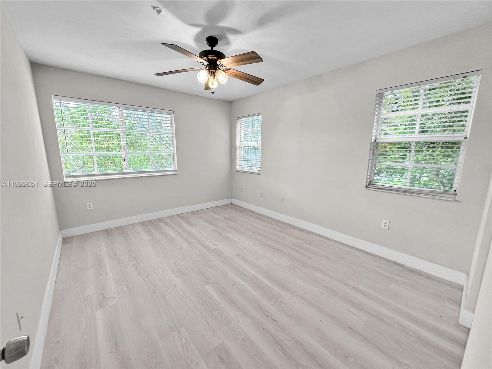 2120 West Preserve Way, Unit 301 Miramar, FL 33025 - Photo 11 of 28 a view of an empty room with a window and wooden floor