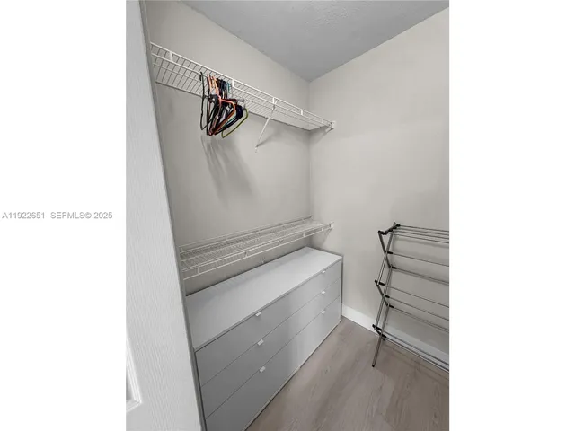 a view of walk in closet with racks