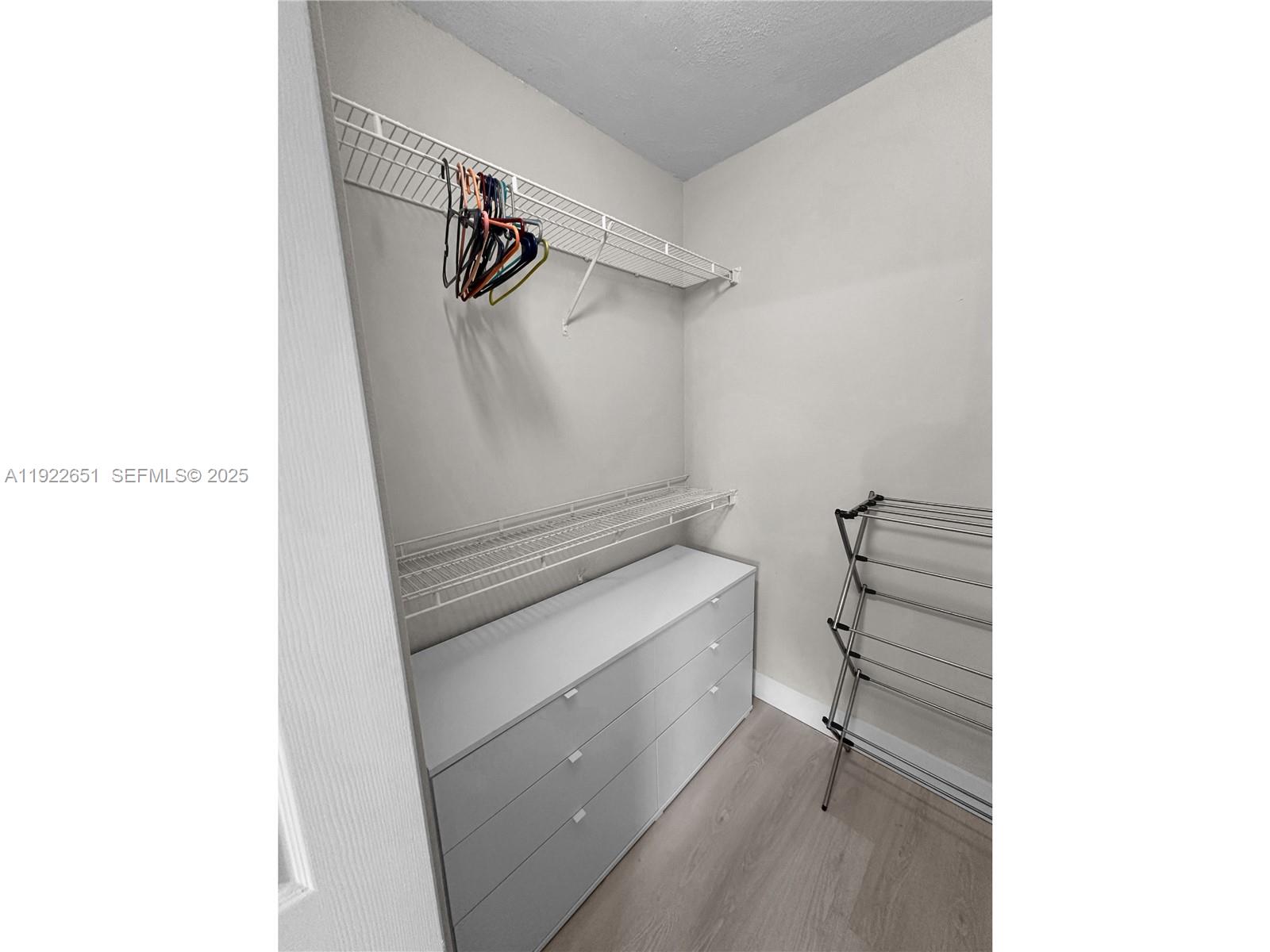 2120 West Preserve Way, Unit 301 Miramar, FL 33025 - Photo 13 of 28 a view of walk in closet with racks