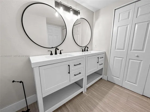 a bathroom with a double vanity sink and a mirror