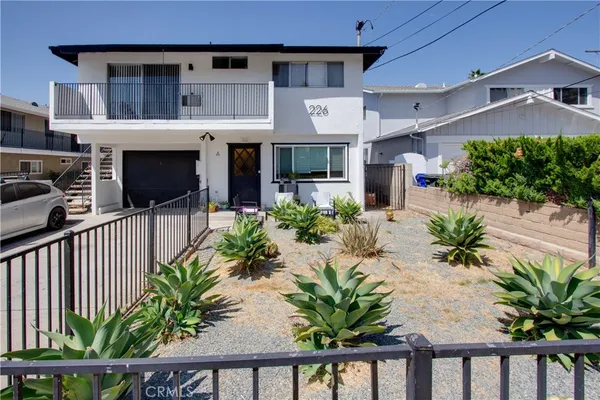 a front view of house with yard and seating space