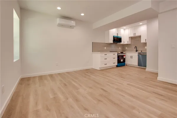 a view of a kitchen with a sink and a refrigerator