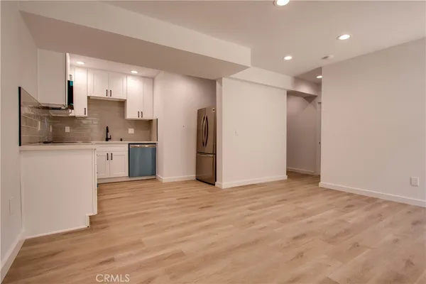 a view of a kitchen with a refrigerator and a microwave