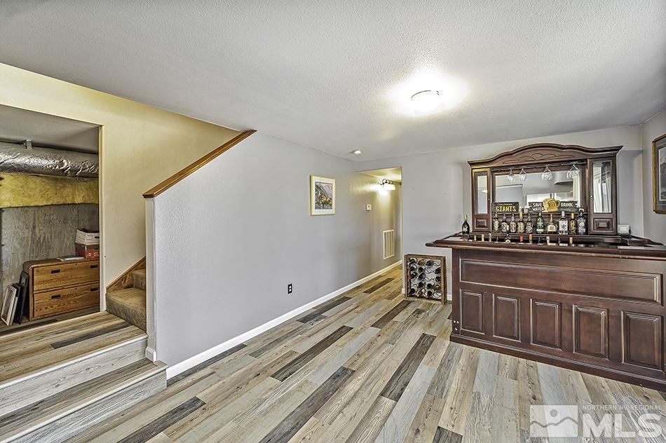 14300 Sitting Bull Circle Reno, NV 89521 - Photo 30 of 32 a view of a hallway to a room with wooden floor and furniture