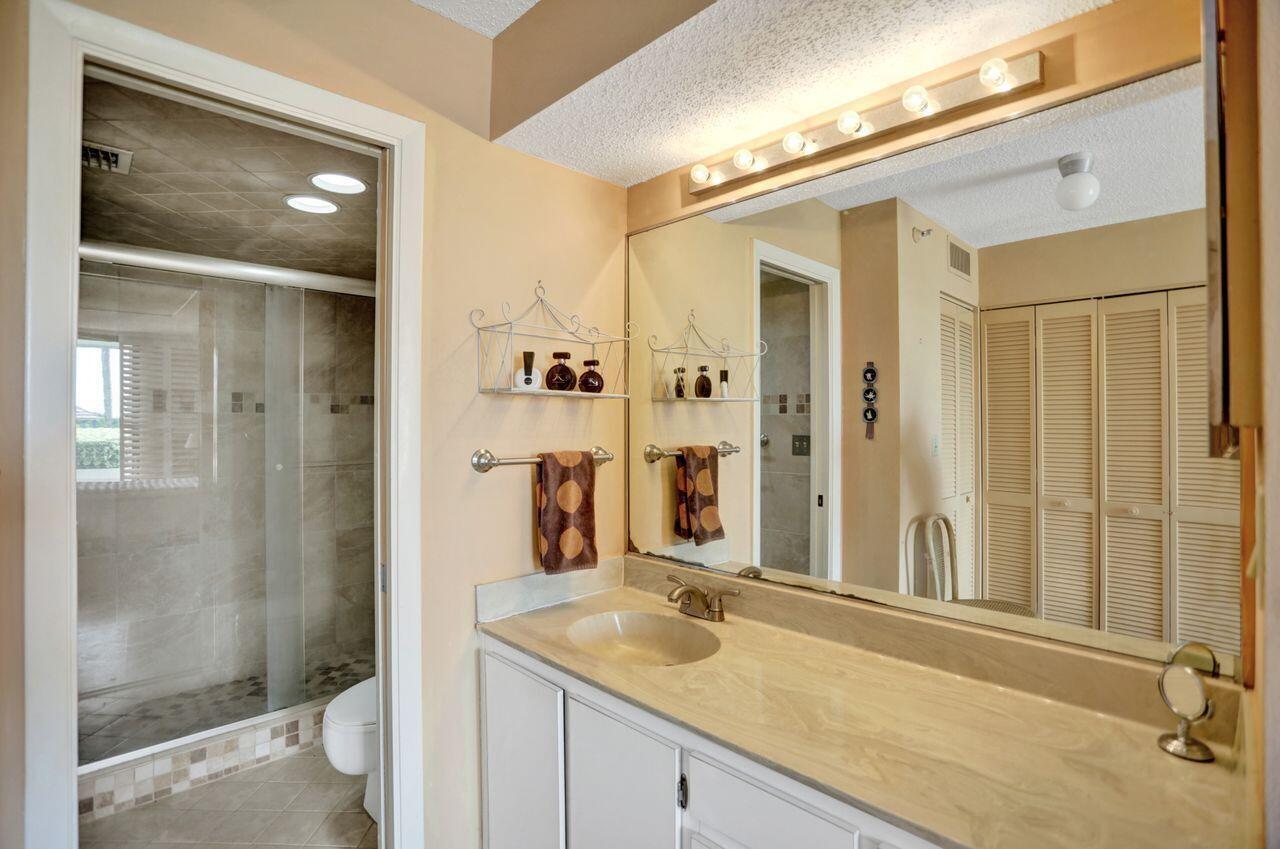 100 Ocean Trail Way, Unit 109 Jupiter, FL 33477 - Photo 7 of 27 a bathroom with a sink and a mirror