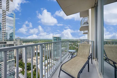 a view of a balcony with a table and chairs