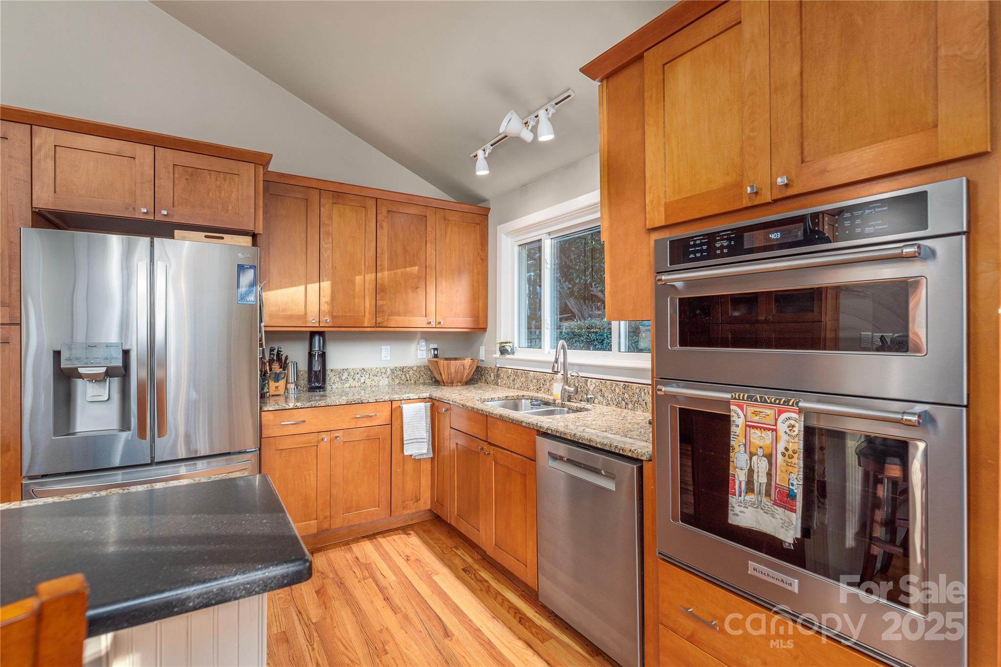 106 Spooks Branch Road Asheville, NC 28804 - Photo 13 of 28 a kitchen with stainless steel appliances granite countertop a refrigerator a stove top oven and sink