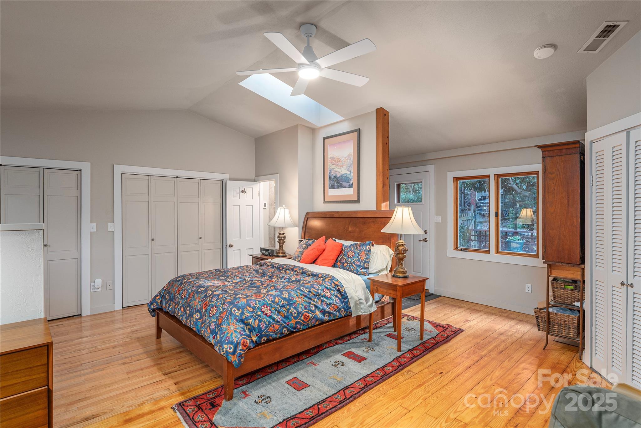 106 Spooks Branch Road Asheville, NC 28804 - Photo 15 of 28 a bedroom with a bed and wooden floor