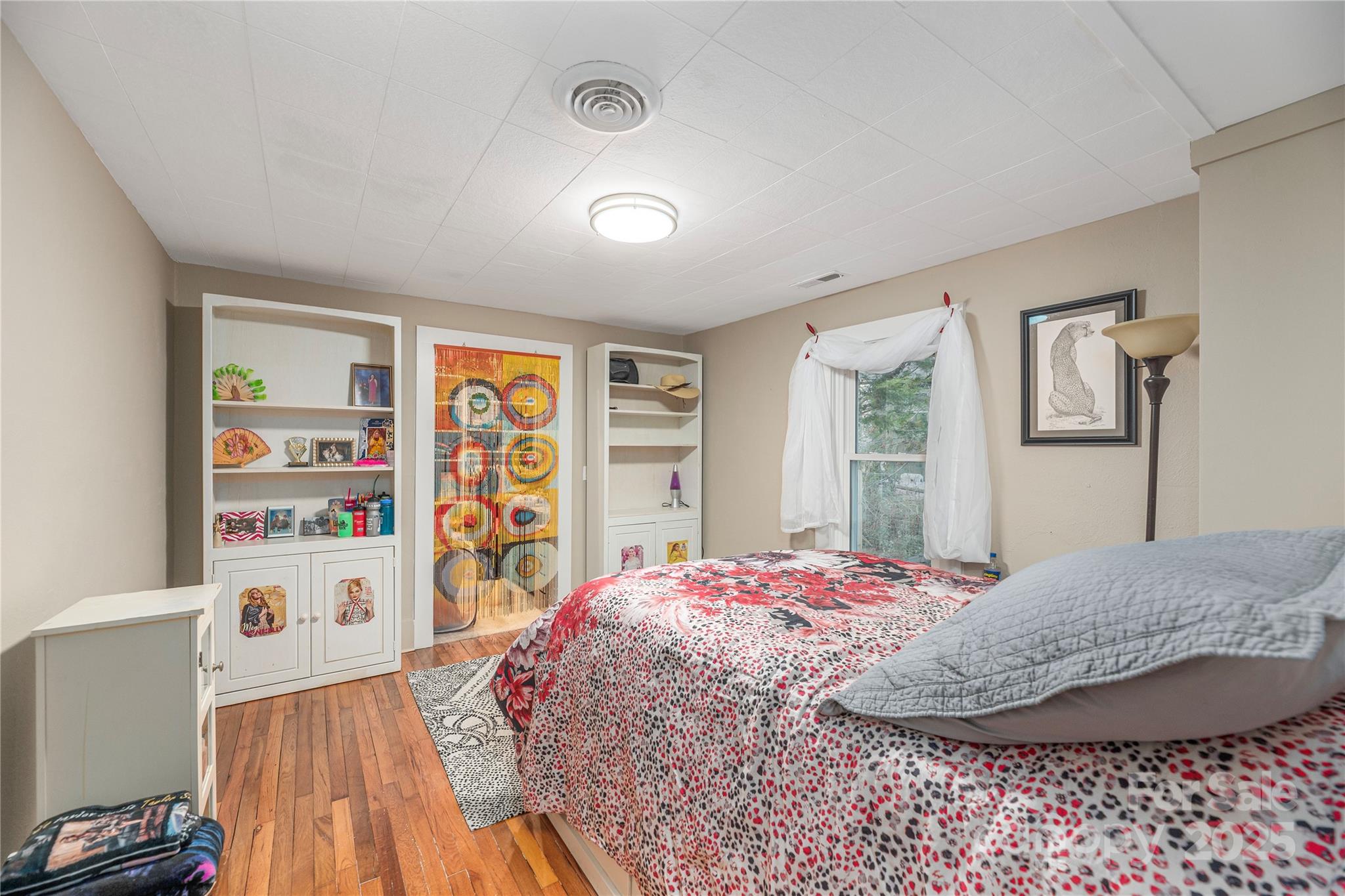 106 Spooks Branch Road Asheville, NC 28804 - Photo 20 of 28 a bedroom with a bed cabinets and a window