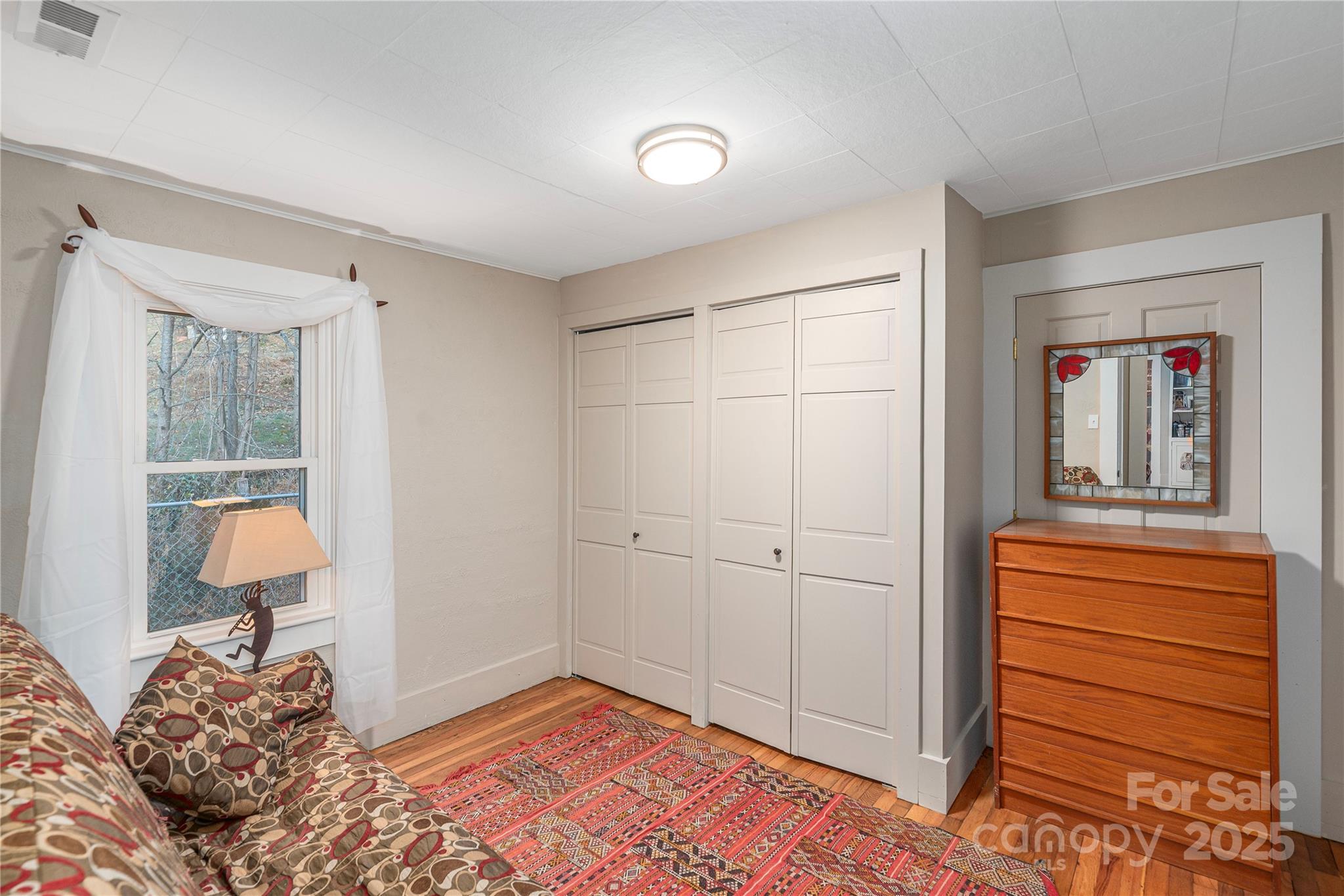 106 Spooks Branch Road Asheville, NC 28804 - Photo 22 of 28 a bedroom with a bed and a dresser