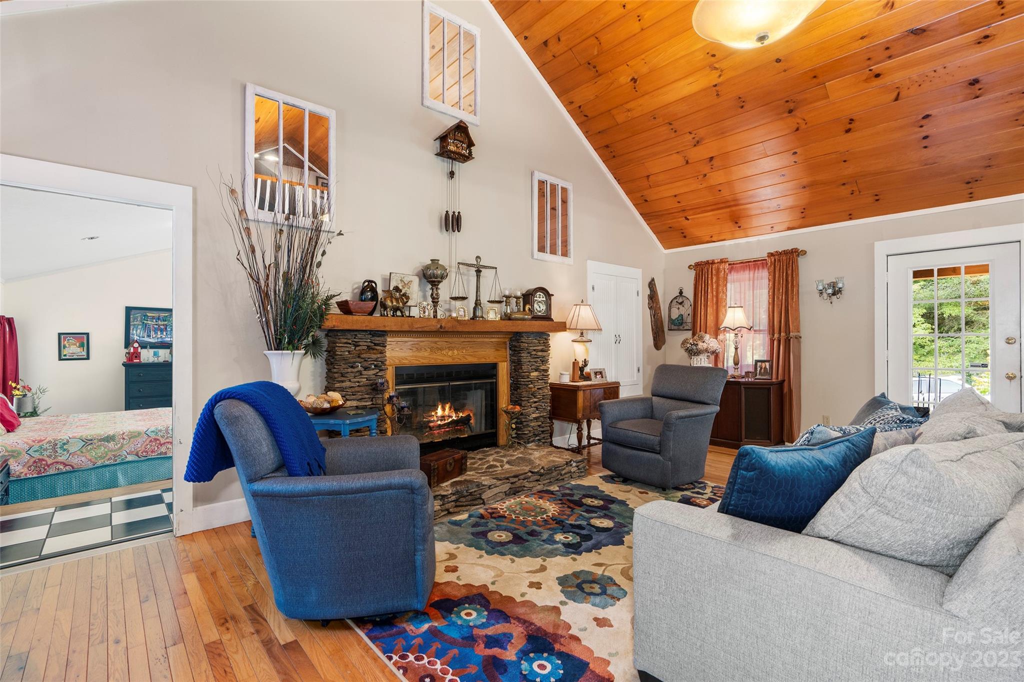 290 Last Mohican Trail Clyde, NC 28721 - Photo 14 of 46 a living room with furniture a fireplace and potted plants