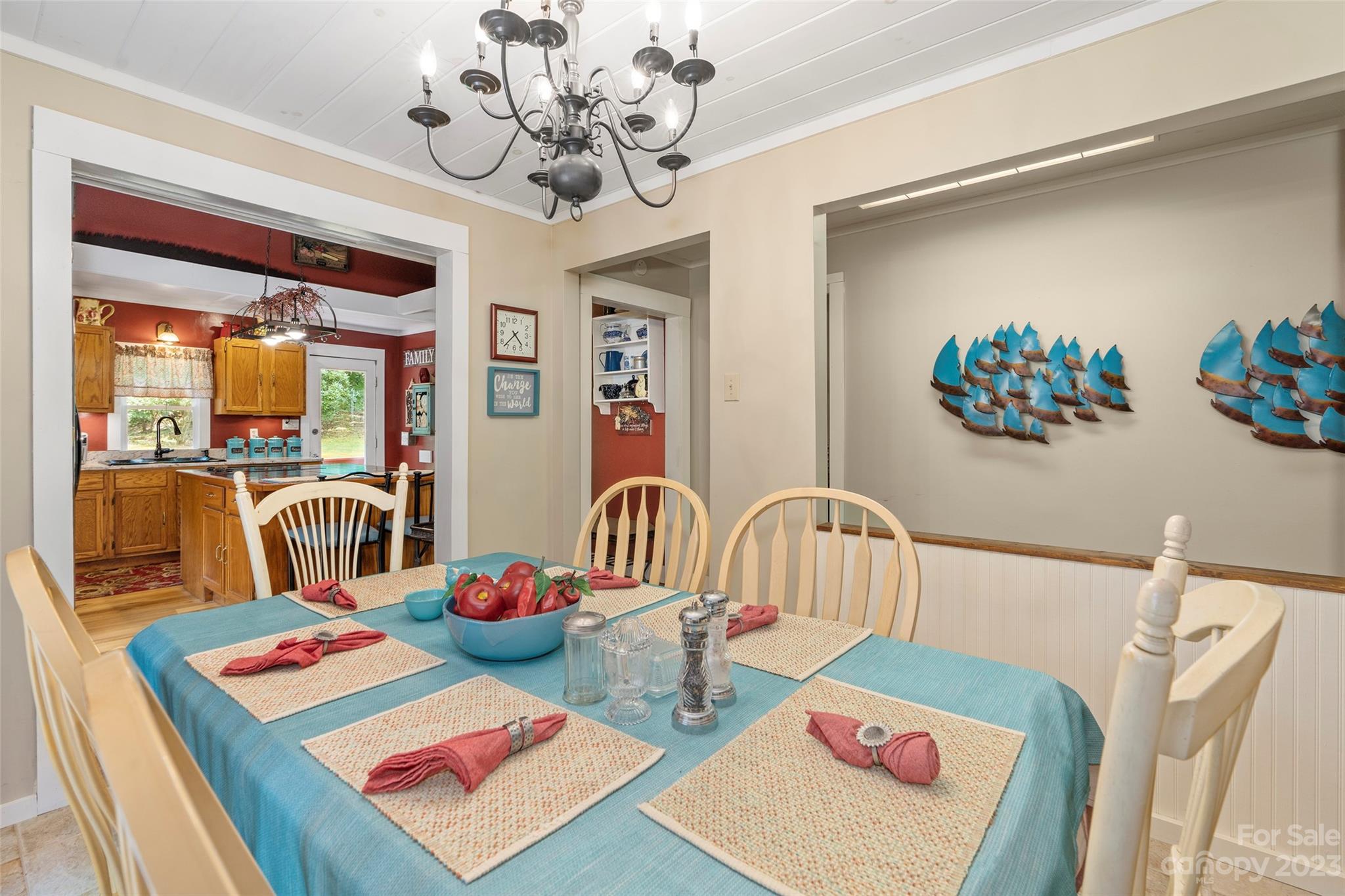 290 Last Mohican Trail Clyde, NC 28721 - Photo 16 of 46 a bedroom with furniture and a chandelier