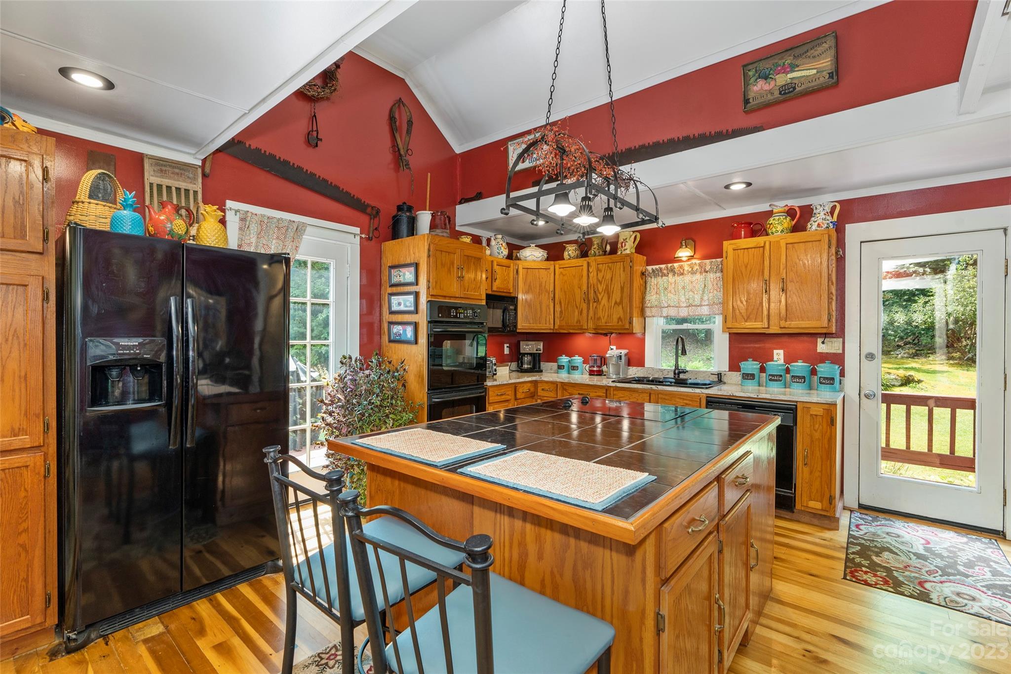290 Last Mohican Trail Clyde, NC 28721 - Photo 18 of 46 a kitchen with a table chairs refrigerator and a window