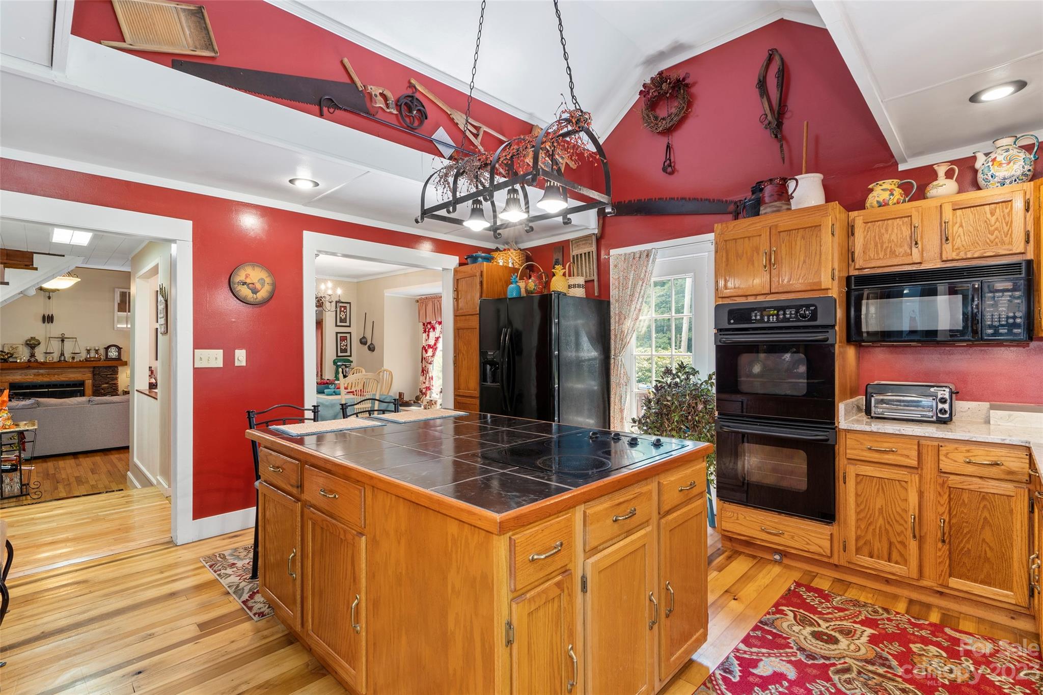 290 Last Mohican Trail Clyde, NC 28721 - Photo 19 of 46 a kitchen with stainless steel appliances granite countertop a sink and a refrigerator