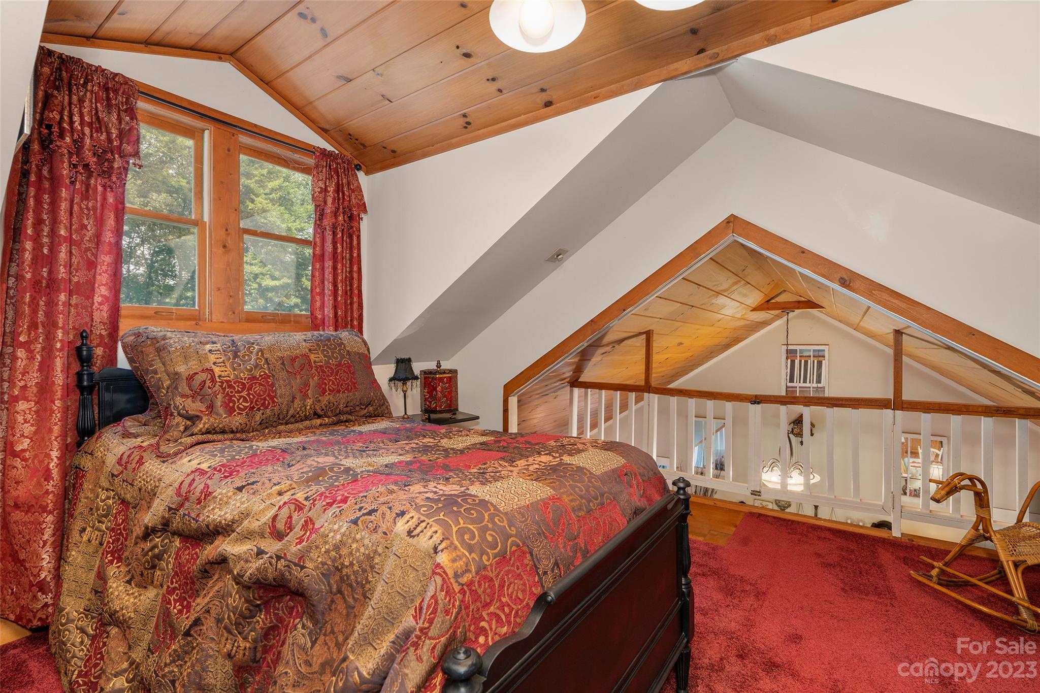 290 Last Mohican Trail Clyde, NC 28721 - Photo 29 of 46 a bed sitting in a bedroom next to a window