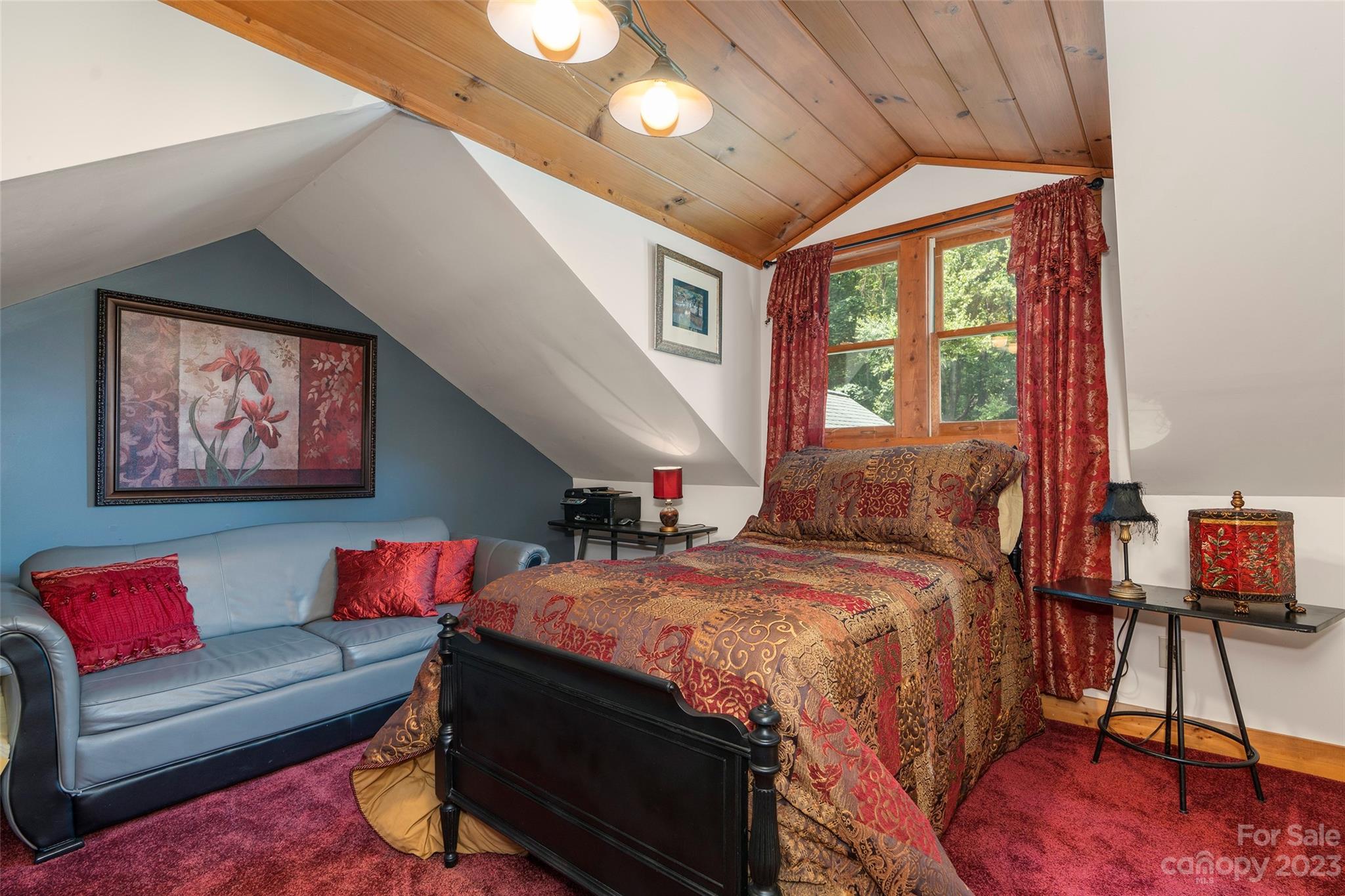 290 Last Mohican Trail Clyde, NC 28721 - Photo 30 of 46 a bedroom with furniture and a large window