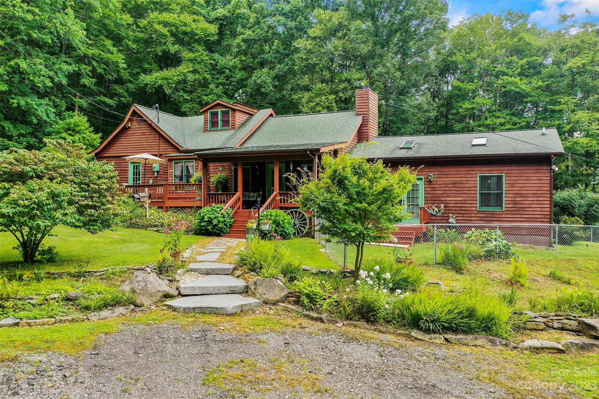 290 Last Mohican Trail Clyde, NC 28721 - Photo 3 of 46 a front view of house with yard and green space