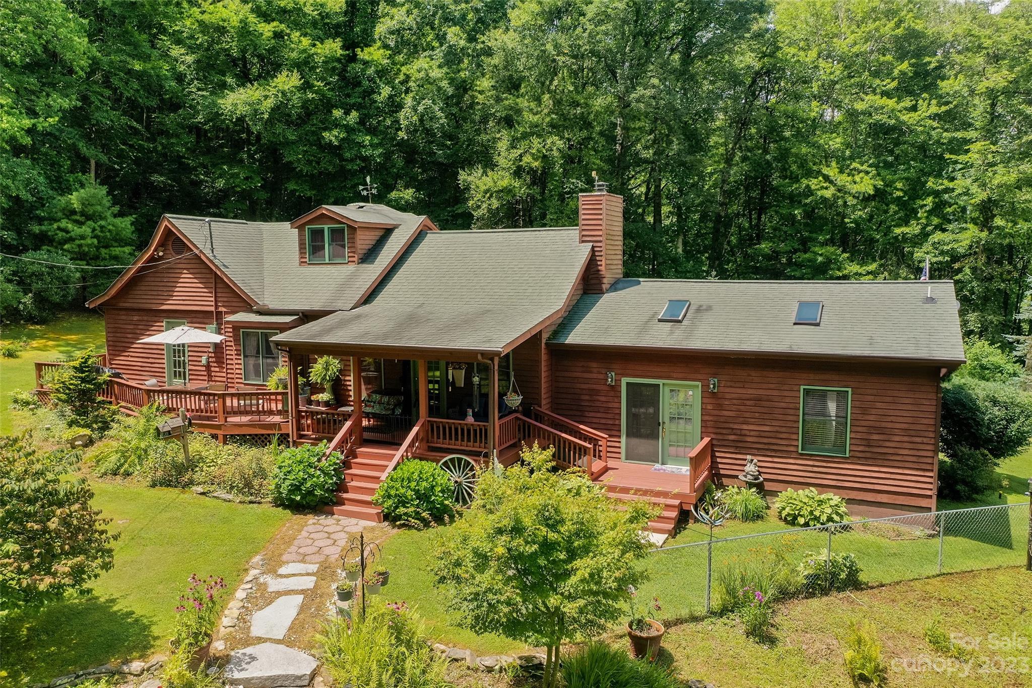 290 Last Mohican Trail Clyde, NC 28721 - Photo 4 of 46 aerial view of a house with pool and chairs