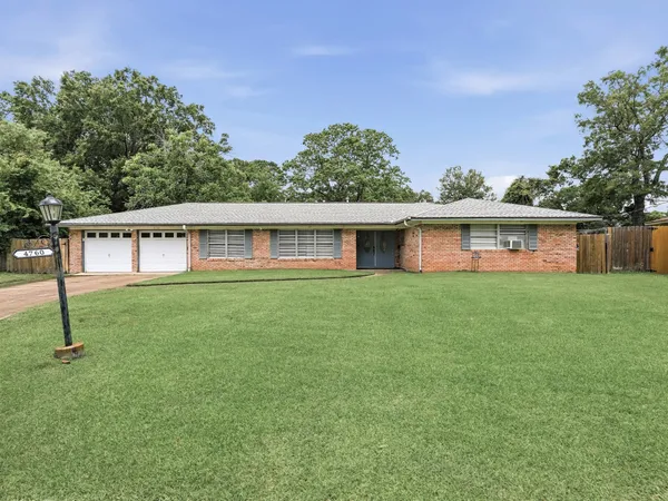a front view of house with a garden