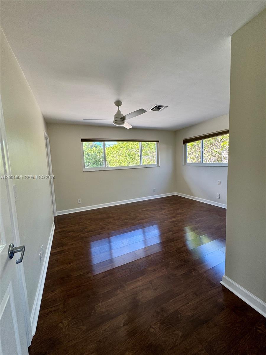 1093 Southwest 14th Street Boca Raton, FL 33486 - Photo 11 of 28 an empty room with wooden floor and windows